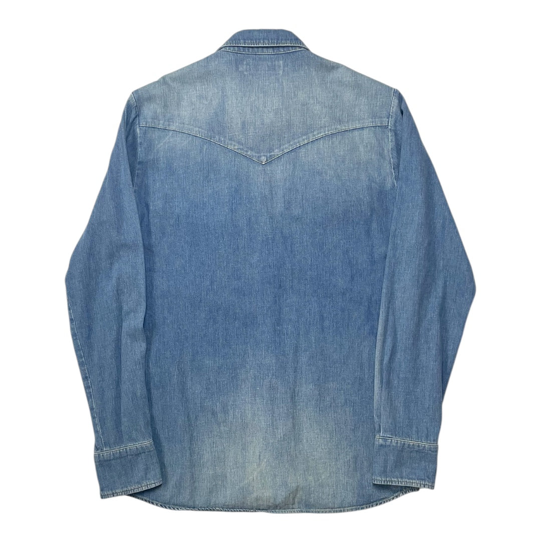 Back view of a blue denim shirt on a white background