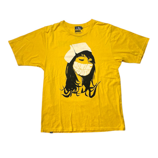 Yellow t-shirt with a graphic design of a person wearing a face mask on a white background